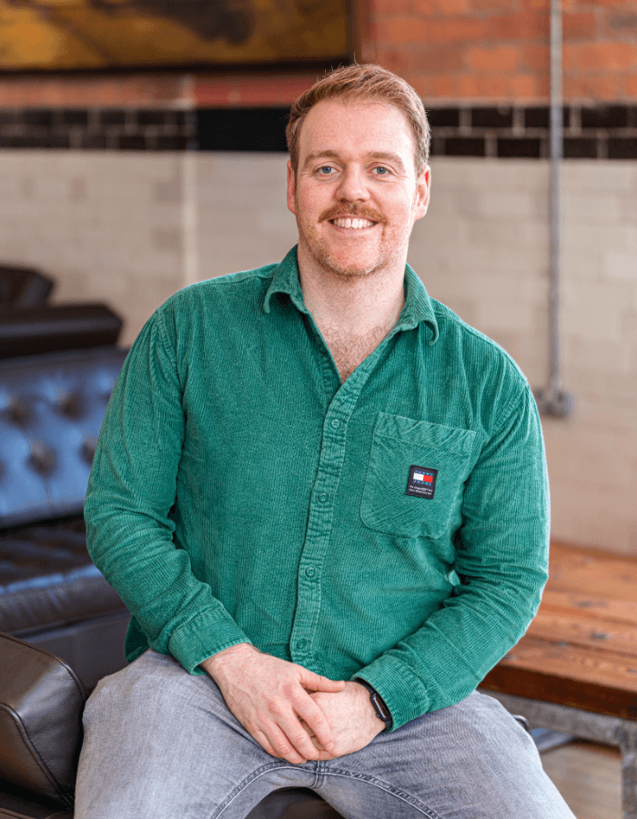 Paul Howell in a green shirt smiling at the camera